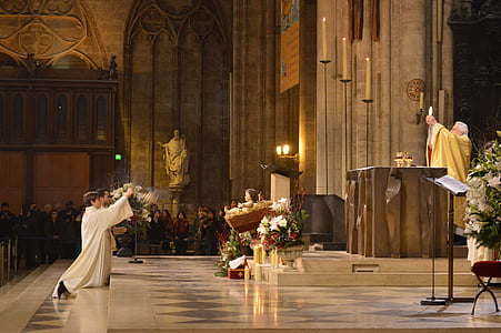 priest in yellow cape in front of the stage thumbnail