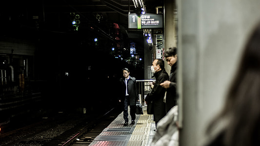 man walking beside train tracks thumbnail