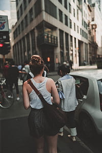 woman in gray tank top and black short shorts walking on street thumbnail