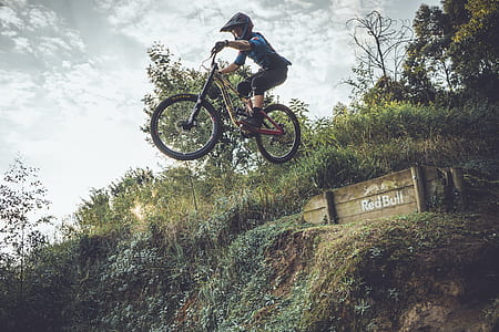 man riding bike doing stunts during daytime thumbnail