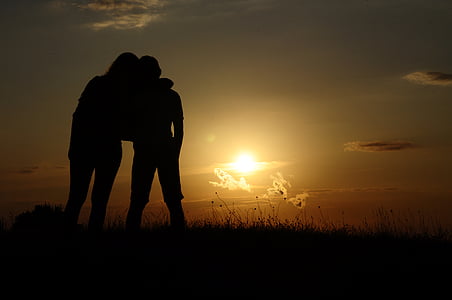 silhouette of two people on grass thumbnail