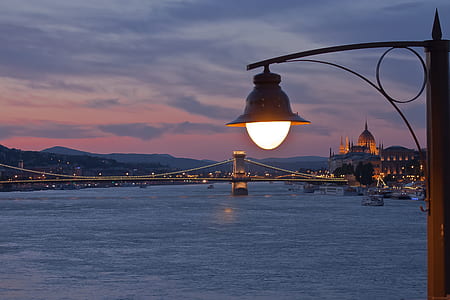 black post lamp beside body of water thumbnail