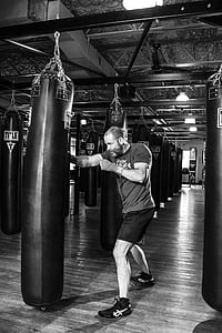 man wearing black shorts beside black leather heavy bag thumbnail