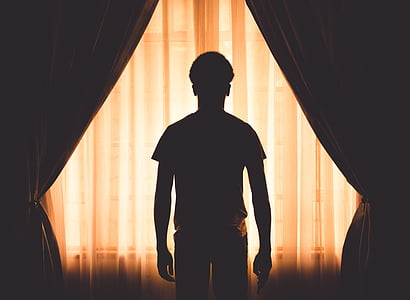 man standing beside curtain thumbnail