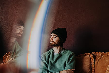 man sitting on brown couch thumbnail