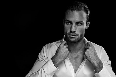 man wearing white shirt holding it's collar thumbnail