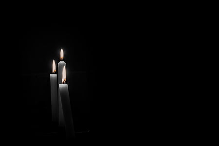 grayscale photography of three white lighted candles thumbnail