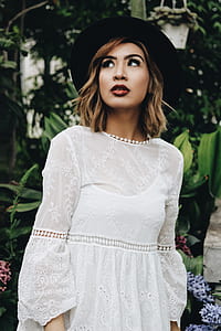 woman standing near green leaf plants thumbnail
