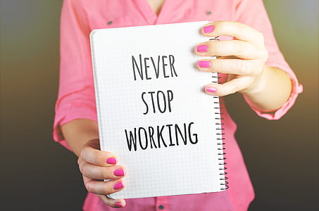 Woman Holding Never Stop Working Print Notebook thumbnail