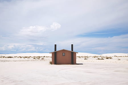 brown wooden house on white farm thumbnail