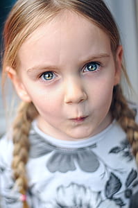 girl wearing white and grey floral crew-neck long-sleeved shirt with braided blonde hair thumbnail