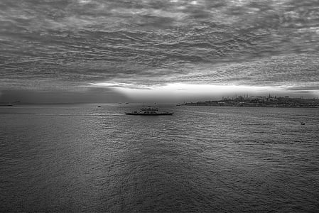 grayscale photography of boat on sea thumbnail