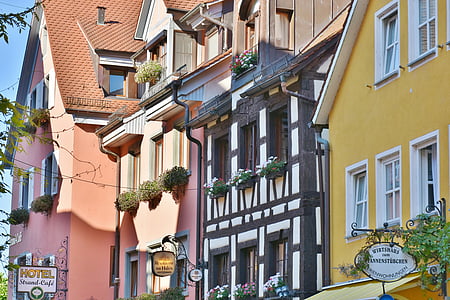 architectural photography of orange and black houses thumbnail