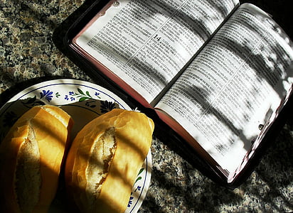 bread near bible with sunlight light thumbnail
