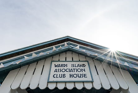 worms eye view of white wooden signage thumbnail