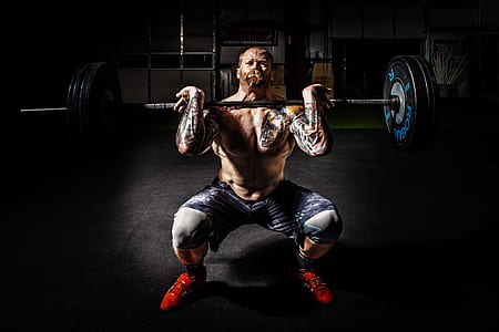 Man in Black Shorts Carrying Adjustable Barbells thumbnail
