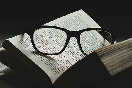 eyeglasses with black frames on open book thumbnail