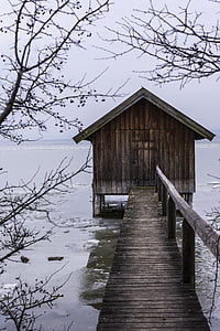 brown wooden shelter on body of water thumbnail
