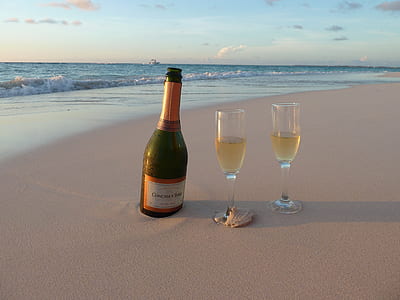 wine glass near glasses on shoreline thumbnail