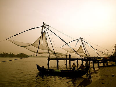 sepia tone photography of group of men on fishing boats thumbnail