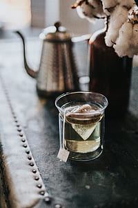 clear tea glass near gray kettle thumbnail