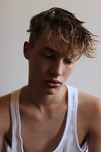 man wearing white tank top taking selfie thumbnail