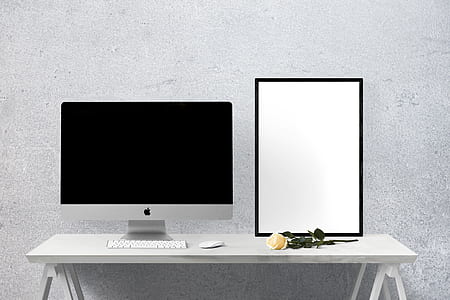 silver iMac on table beside yellow rose thumbnail