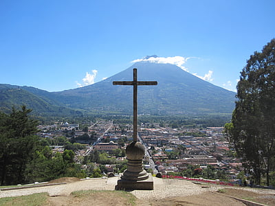 cross overlooking the volcano under blue sky thumbnail