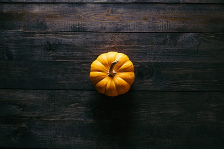 yellow pumpkin on brown wooden board thumbnail