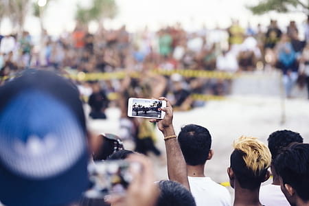 person holding smartphone focusing with people sitting in front thumbnail