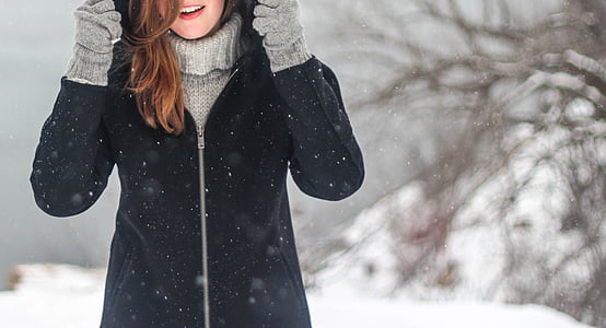 depth of field photography of woman in hoodie under winter season thumbnail