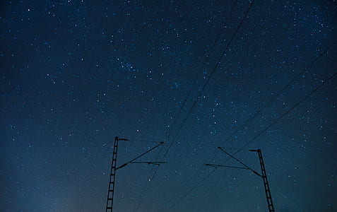 black utility posts under nighttime thumbnail