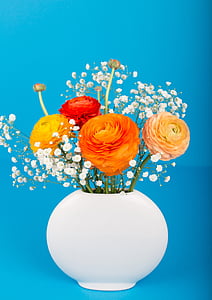 orange, yellow, and red petaled flowers in white ceramic vase thumbnail