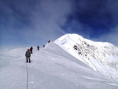 group of people standing on mountain covered with snow thumbnail