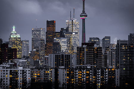 high rise buildings under cloudy sky thumbnail