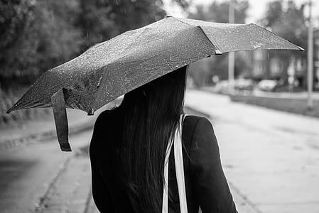 woman using umbrella grayscale photo thumbnail