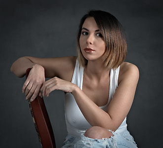 woman wearing white tank tops seating of brown table thumbnail