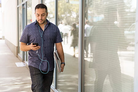 man about to walk near glass wall thumbnail