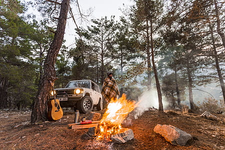 person camping on woods with bonfire thumbnail