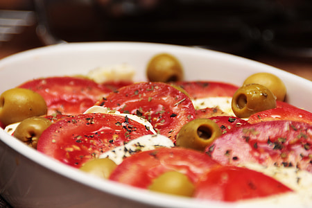 sliced tomatoes and pickles on white ceramic bow l thumbnail