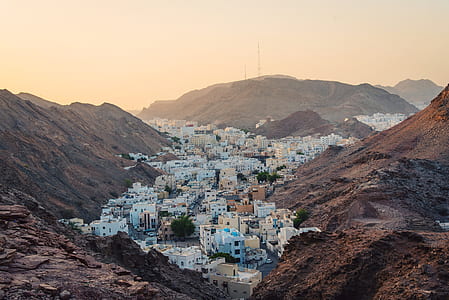 buildings between two brown mountains thumbnail
