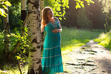 woman green sleeveless dress standing beside tree thumbnail