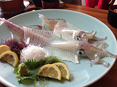 squid sashimi placed on teal ceramic plate thumbnail