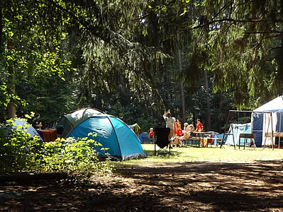 people near camping tents and green trees during daytime thumbnail
