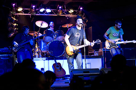 group of male performing at stage front of people thumbnail