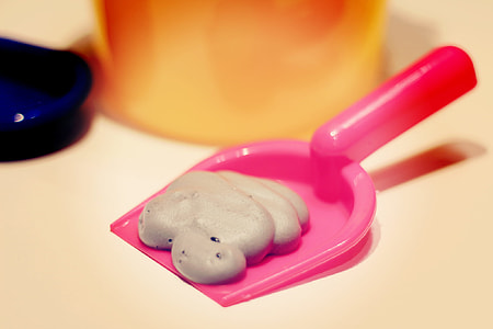 gray fluffy slime on pink dust pan thumbnail