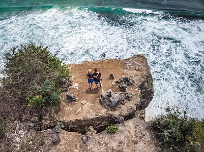 Photography of People Standing Near Cliff thumbnail