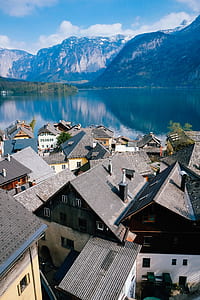 houses beside body of water at daytime thumbnail