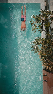 man swimming on blue pool thumbnail