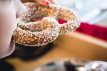 Eating pretzel with sesame seeds thumbnail